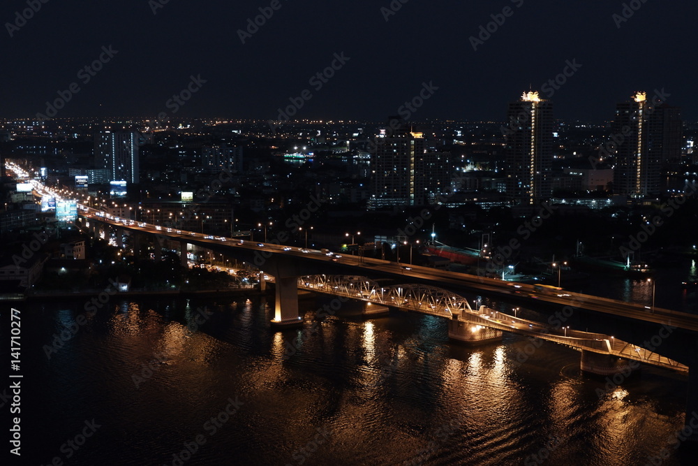 night picture of car crossing bridge in Bangkok over Chao Phraya River with slow shutter speed night picture of car crossing bridge in Bangkok over Chao Phraya River with slow shutter speed