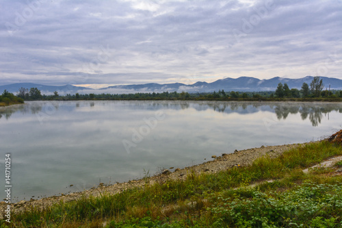Fototapeta Naklejka Na Ścianę i Meble -  Lake in the mountains for recreation and fishing. Early morning