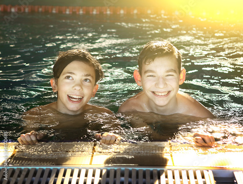 teenager boys in open air swimming pool photo