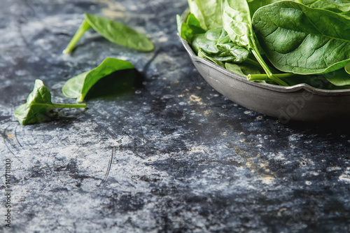 Washed fresh mini spinach on the old concrete table