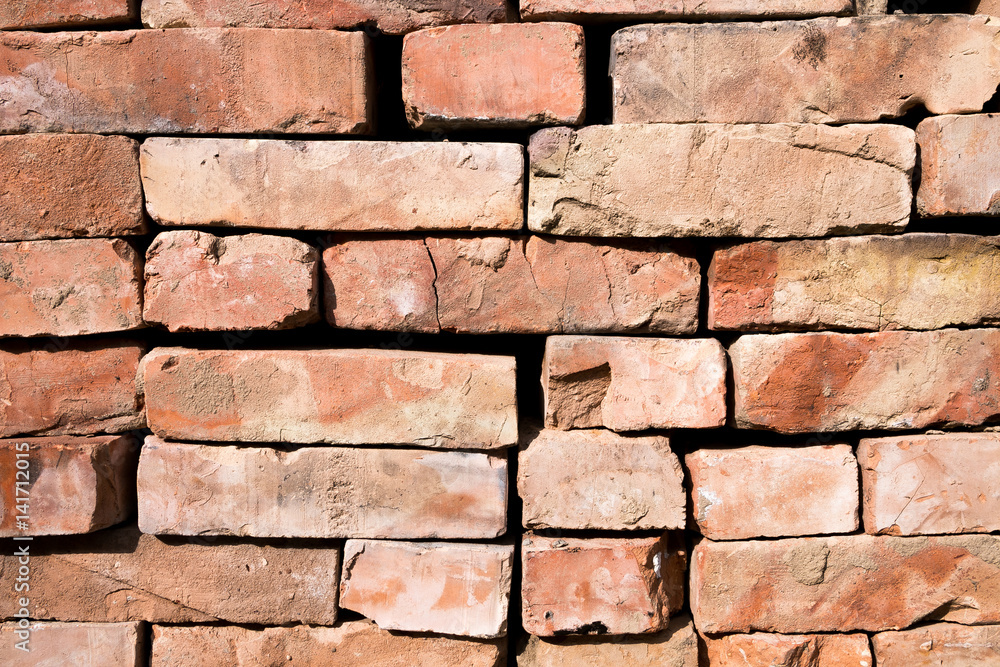 Obraz premium Red brick wall background with copy space. Used Rustic Bricks Piled.