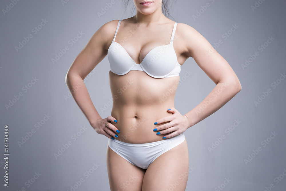 Woman in white underwear on gray background, perfect female body