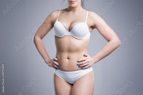 Woman in white underwear on gray background, perfect female body © staras