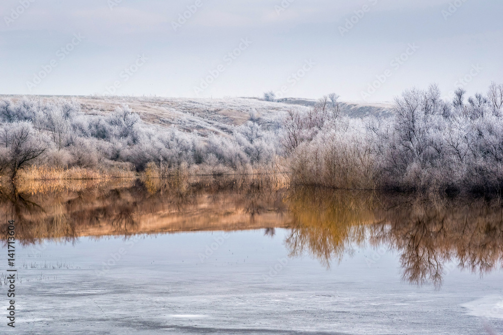 View of the lake, where the winter merges with early spring. View of the lake, where the winter merges with early spring.