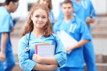 Young student with groupmates outdoors