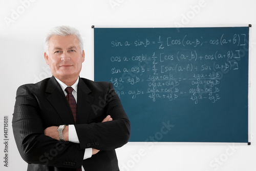 Senior teacher beside black...