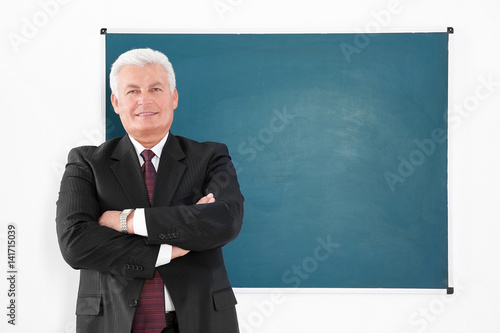 Senior teacher beside black...