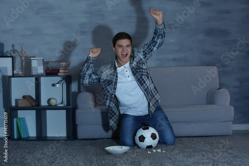 Teenager watching football ...