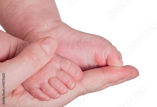 infant legs in mother hand isolated on white