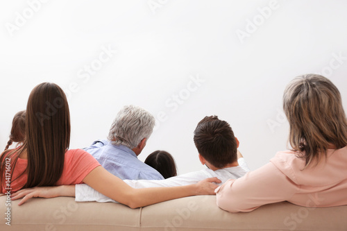 Happy family watching TV on...