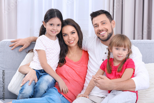 Happy family on sofa in the...