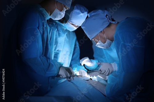 Surgeons operating patient ...