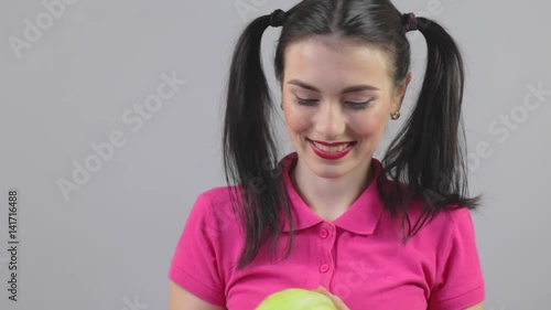 Pretty brunette young woman holding with two hands an cabbage. Advising healthy diet for wellness