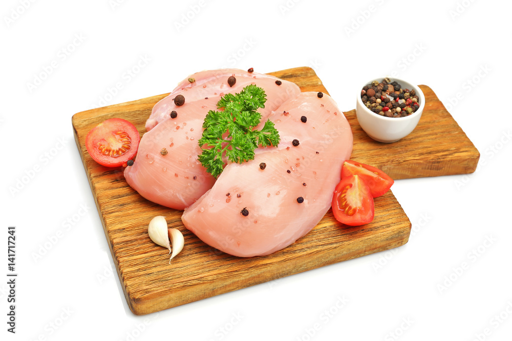 Board with raw chicken breast on white background