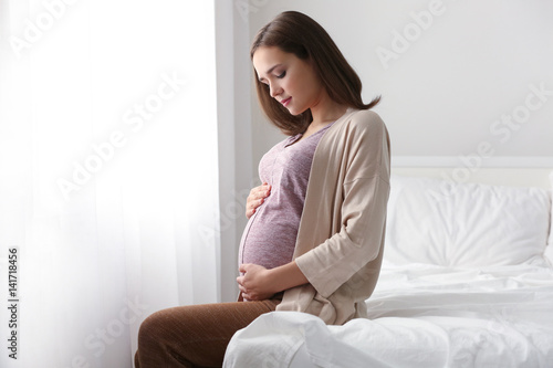 Beautiful pregnant woman si...