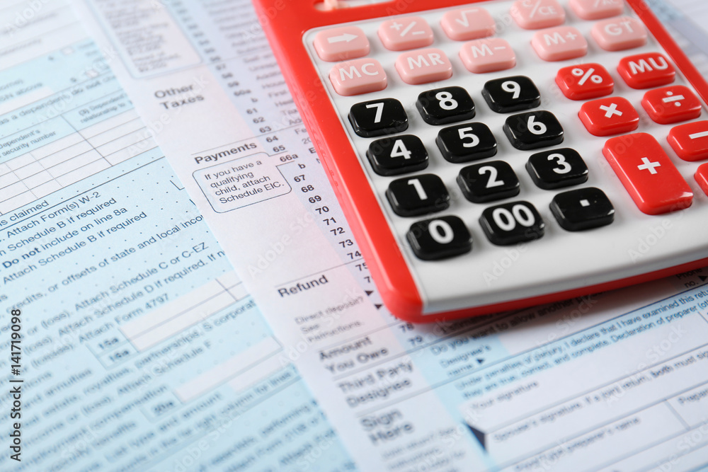 Calculator with documents on table. Tax concept Calculator with documents on table. Tax concept