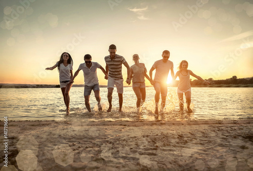 Silhouette of group young people on the beach.