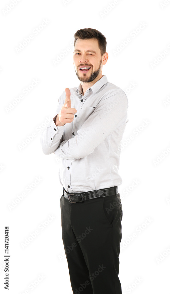 Handsome businessman in elegant suit winking and pointing on white background Handsome businessman in elegant suit winking and pointing on white background