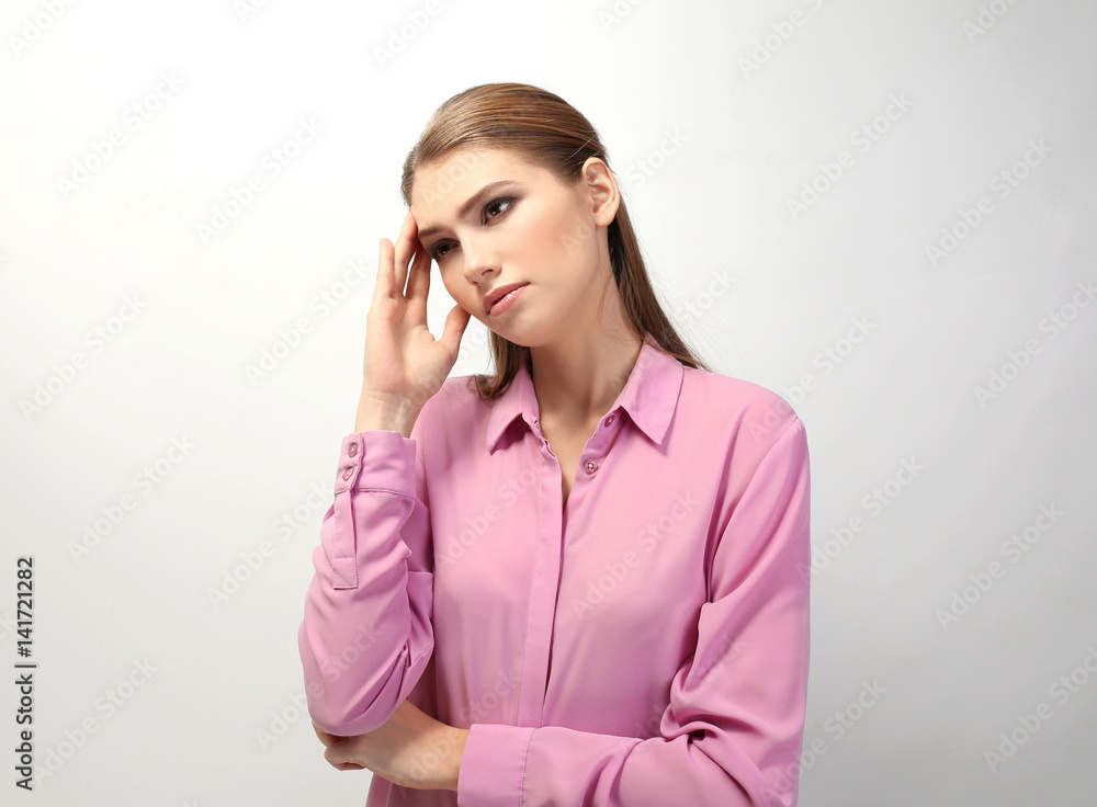 Beautiful young woman suffering from headache on white background Beautiful young woman suffering from headache on white background