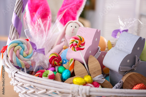 Beautiful Easter basket with traditional decorations and treats  close up