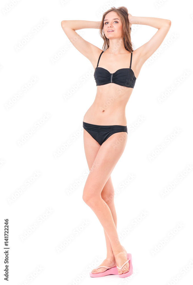 Sexy young woman posing in a black bikini, isolated on white background