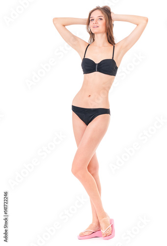 Sexy young woman posing in a black bikini, isolated on white background