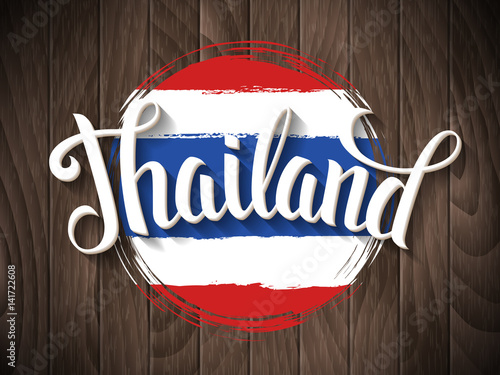 Thailand lettering and thai national flag on vintage wooden background. Vector hand drawn typography poster. Retro calligraphic design.