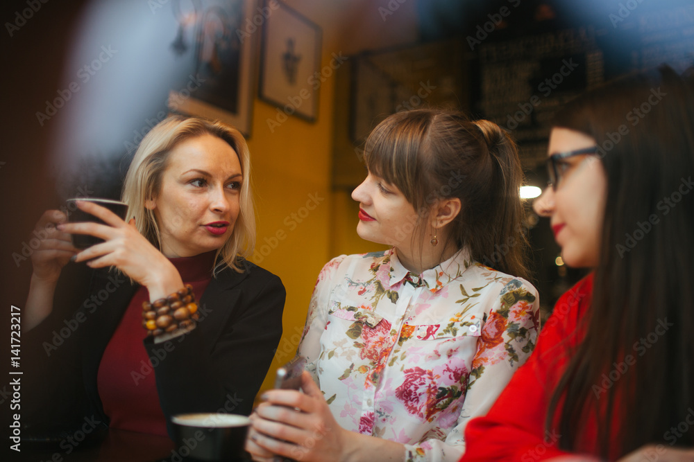 Female friends sitting in cafe Female friends sitting in cafe