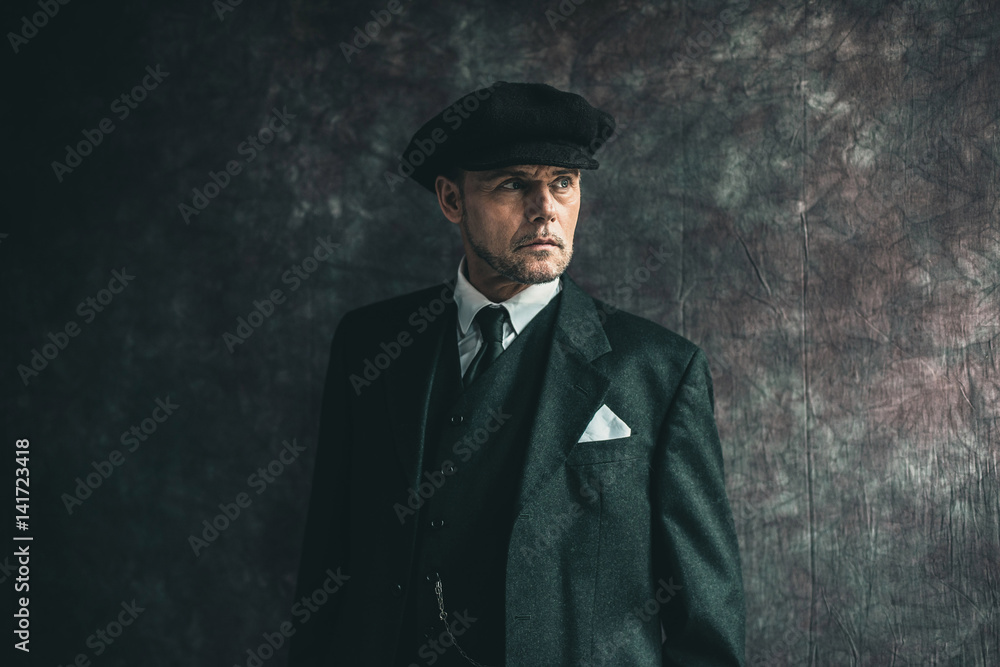 Retro 1920s english gangster wearing flat cap and suit. Stock Photo | Adobe  Stock