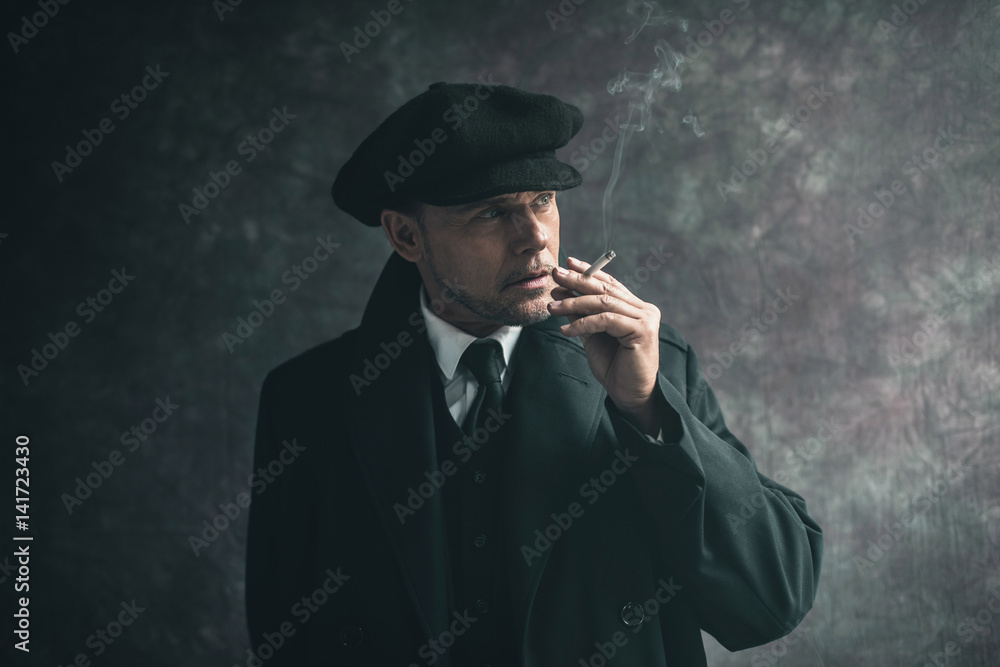 Retro 1920s english gangster smoking 