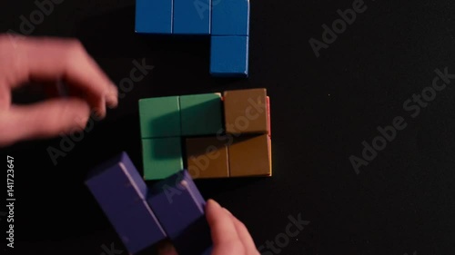 Man's hand picking 3D tetris