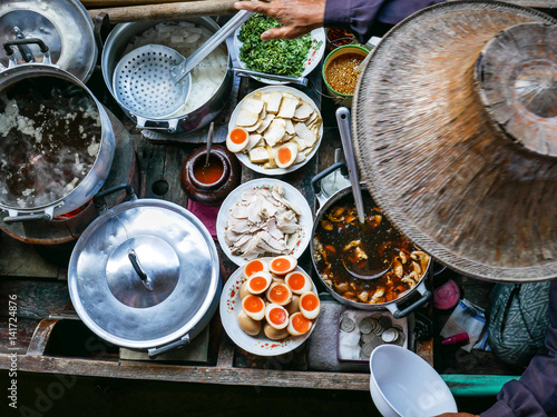 Photography Colored thai food in floating market, food seller with traditional hat in Thaila