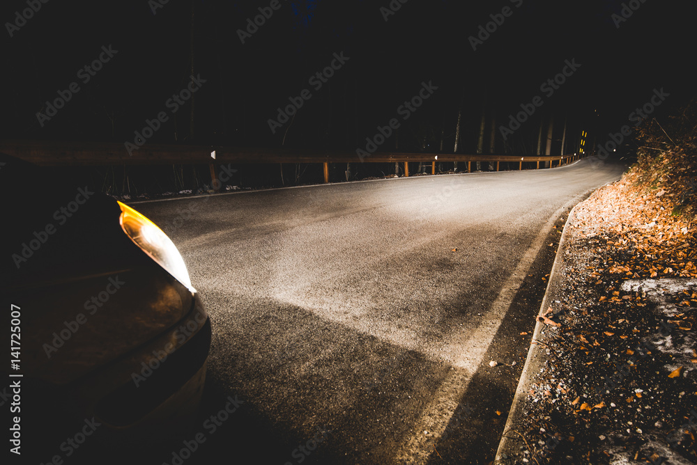 the headlights of a car on mountain road in the night - concept driving safety - obrazy, fototapety, plakaty 