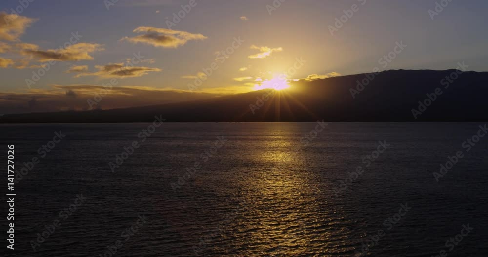 Sunset Behind Ocean and Island in Hawaii