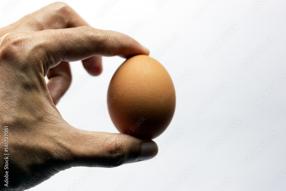 A man holding an egg. A food concept. A man holding an egg. A food concept.