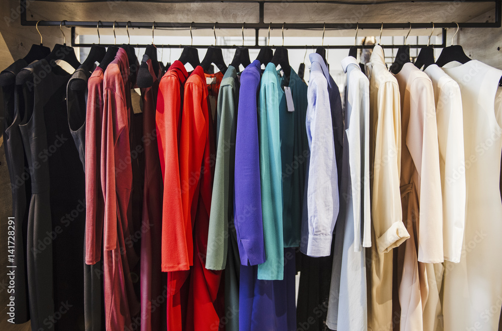 Colorful clorhes on racks in a fashion boutique