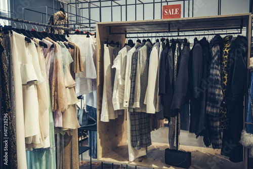 Colorful clorhes on racks in a fashion boutique photo