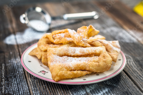 Flancat- crisp deep fried pastry dusted with powdered sugar