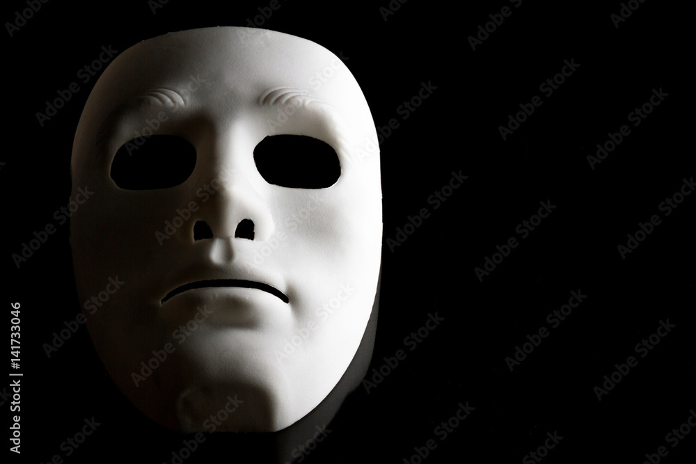 White human face mask on black background. White human face mask on black background.