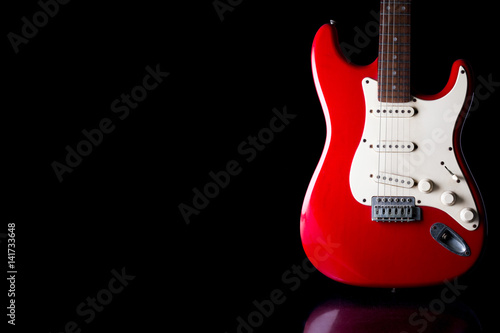 Fotomurale Electric guitar on black background. Free space for text