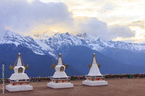 Meili snow mountain and Tibetan stupa, viewpoint from Feilai temple, Deqing, Yunnan, China photo