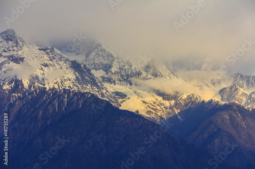 Meili snow mountain in sunrise and Mingyong glacier, at Feilai temple, Deqing, Yunnan, China photo