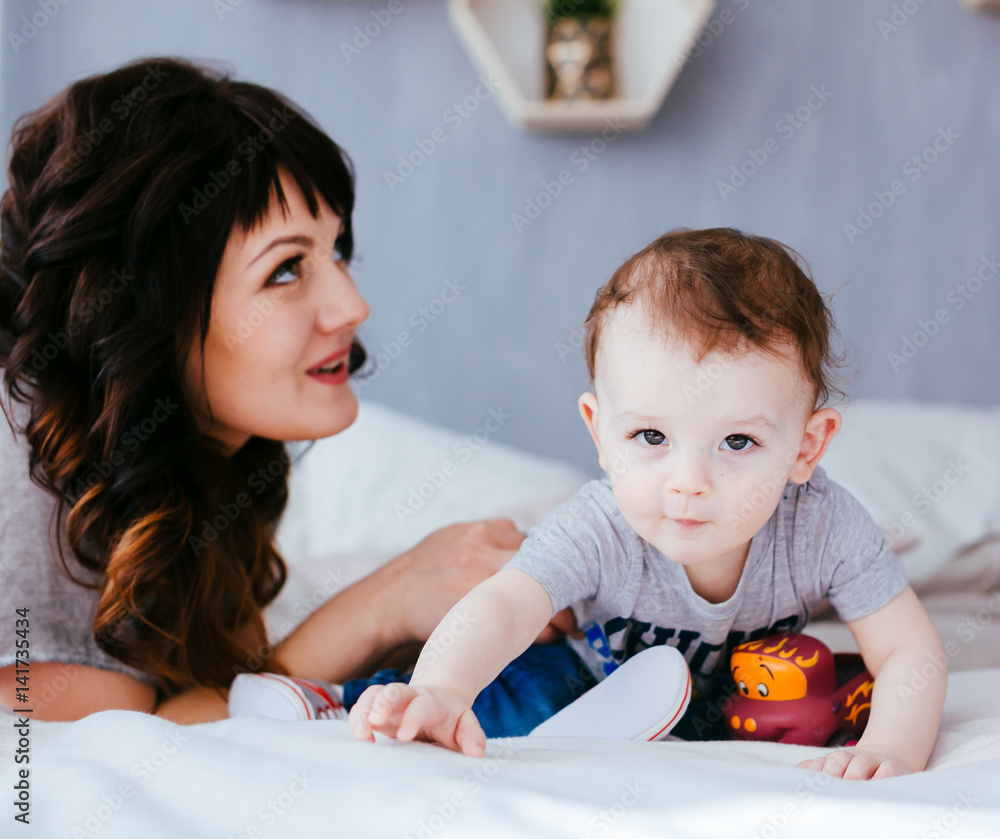 The mother with son sitting on the bed The mother with son sitting on the bed