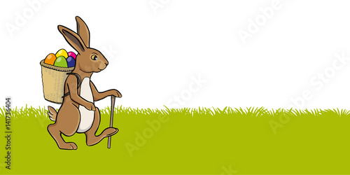 osterhase auf wiese mit stock und tragkorb voll ostereier