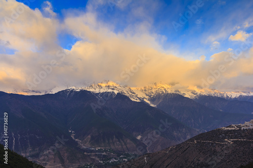 Meili snow mountain in sunrise and golden light at mountain peak, Feilai temple, Deqing, Yunnan, China