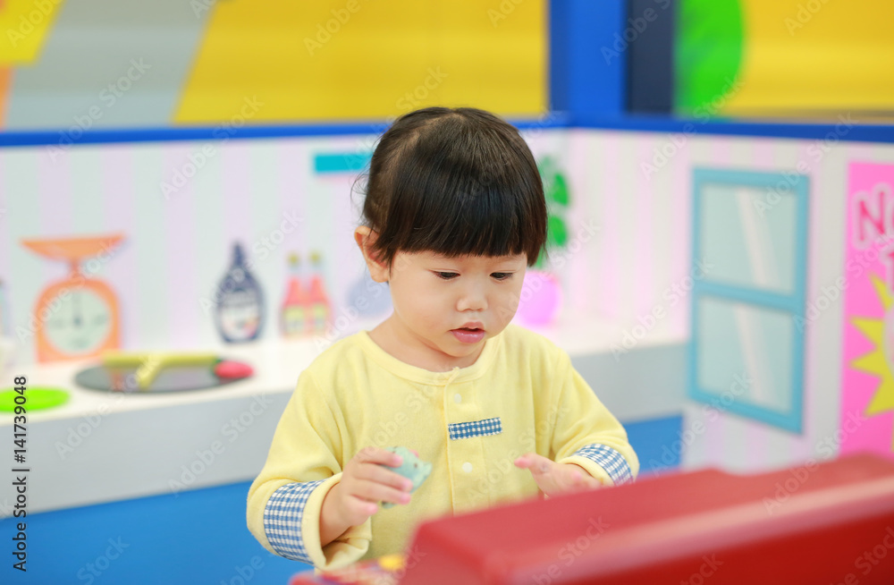 Little girl playing pretend as a sale in ice-cream shop Little girl playing pretend as a sale in ice-cream shop