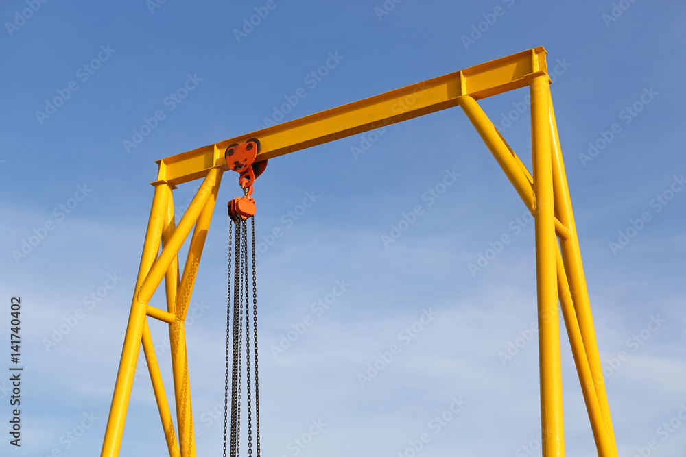 Crane for construction cradles against blue sky