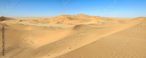 Big sand dunes panorama. Desert or beach sand textured background.