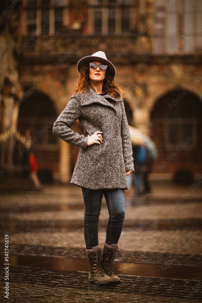 Beautiful Girl in the city centre with hat and sunglasses
