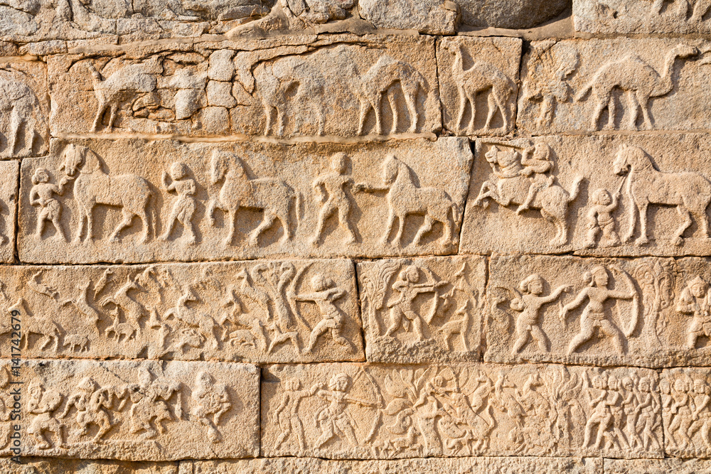 Images of people and animals on a wall in Hampi Images of people and animals on a wall in Hampi